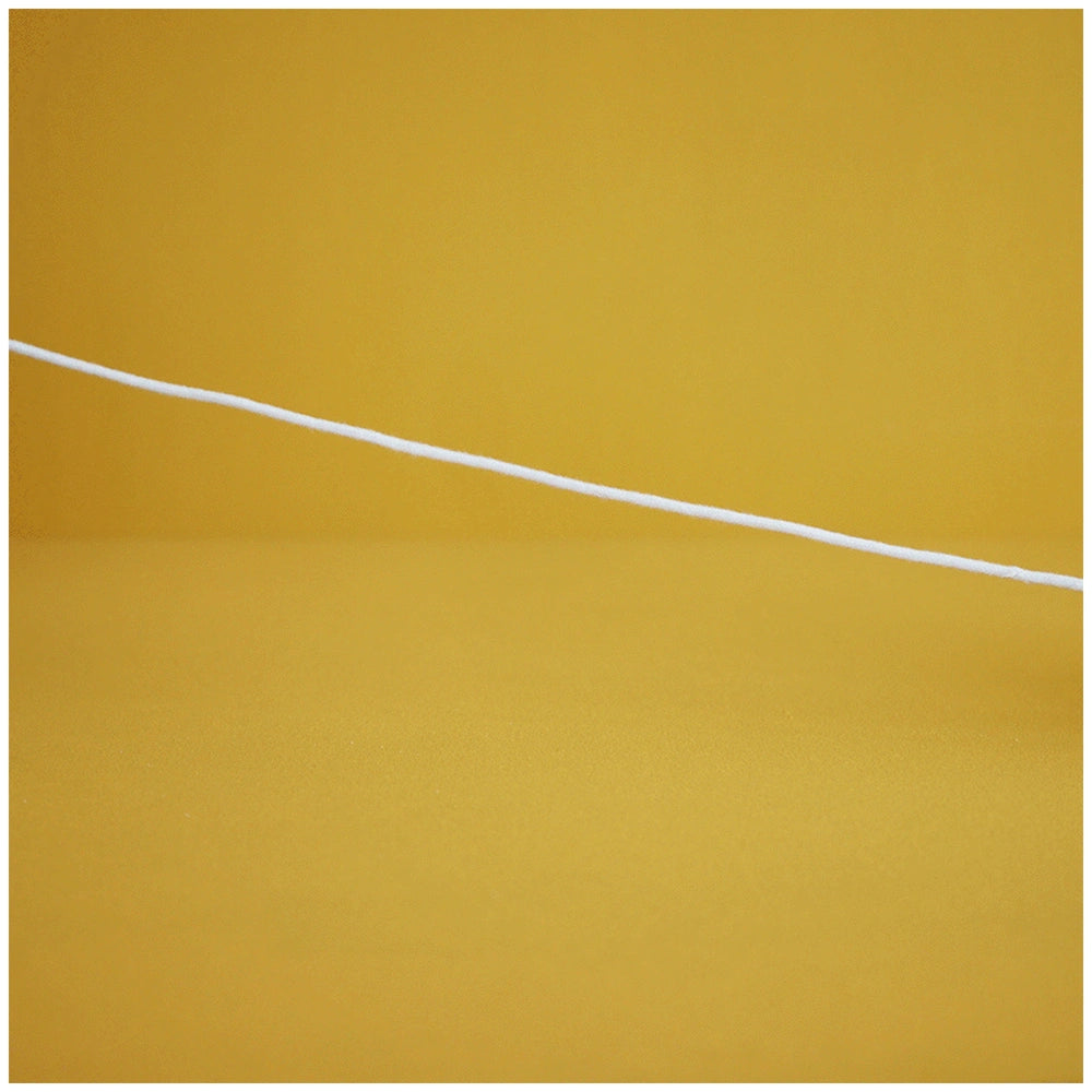 A white cotton cord stretches across a vibrant yellow background, suggesting playfulness and connection for children's toys.