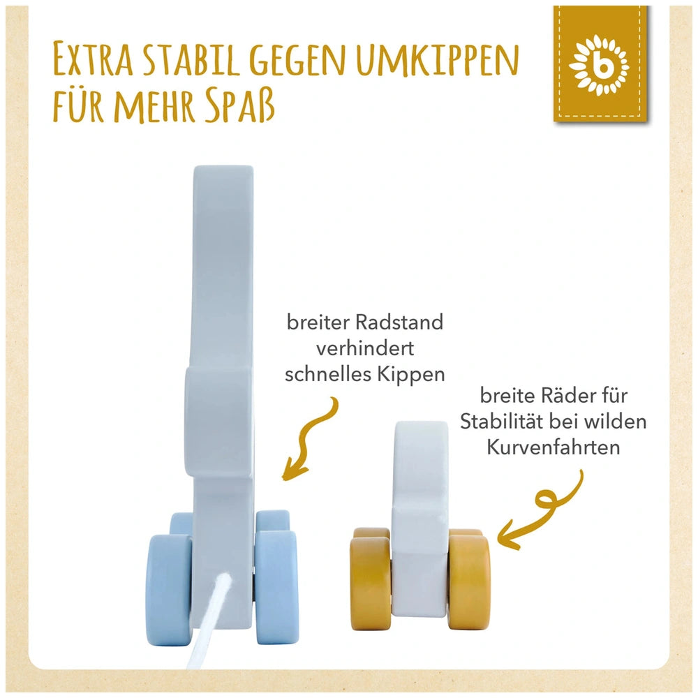 Pull-along toy featuring two elephants in light blue and yellow colors, showcasing the wider wheels for stability. Text highlights the design benefits.