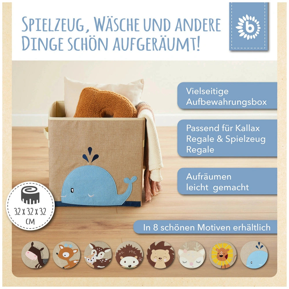 Whale storage box in sand and sky blue with a playful design, filled with blankets, placed on a wooden floor in a child’s room.