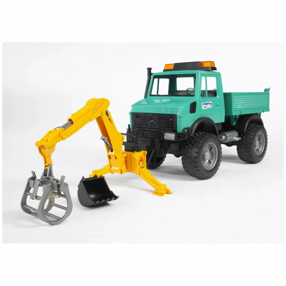 Green toy truck with a yellow Bruder rear hydraulic arm and interchangeable grabber and bucket, designed for farming play.