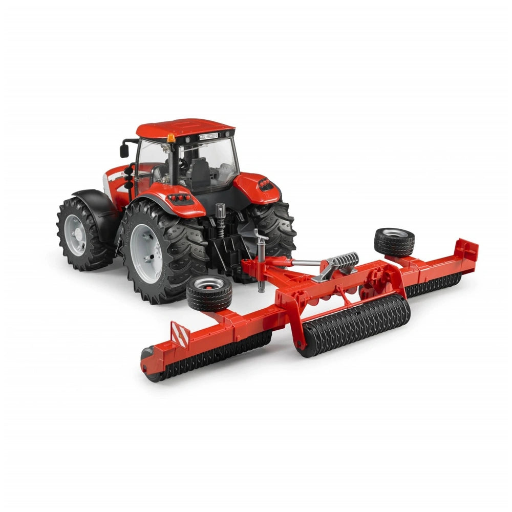 Red Bruder Cambridge Roller toy vehicle with tractor and large agricultural rollers.