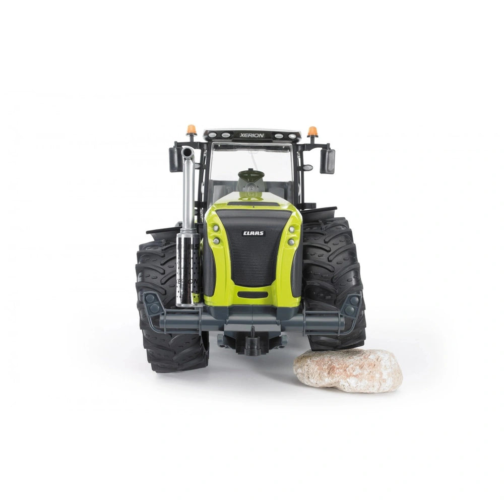 Front view of Bruder Claas Xerion 5000 toy tractor, lime green and black, with realistic large tires.