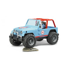 Blue Jeep Cross Country Racer toy with driver, number 81, rugged tires, and red accents on rocky terrain.