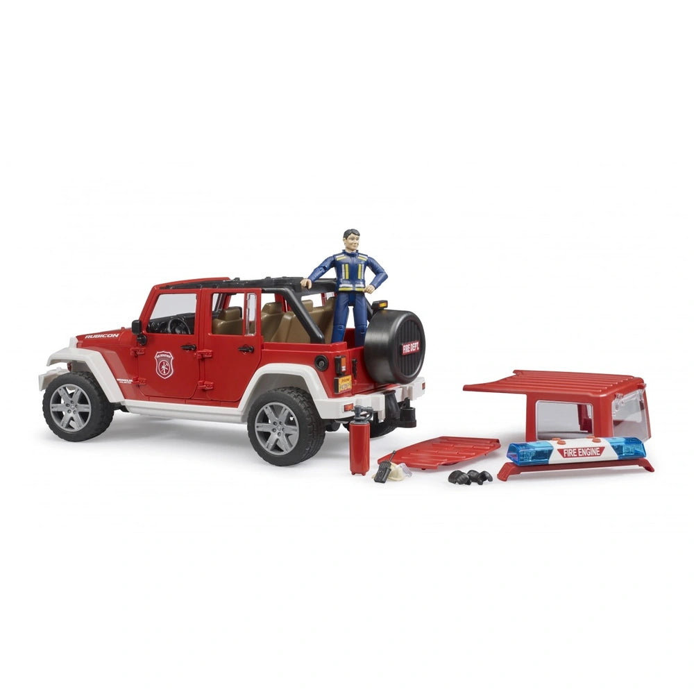 Red Bruder Jeep Wrangler Rubicon toy with fire department decals, a firefighter figure, and accessories like a roof rack and extinguisher.