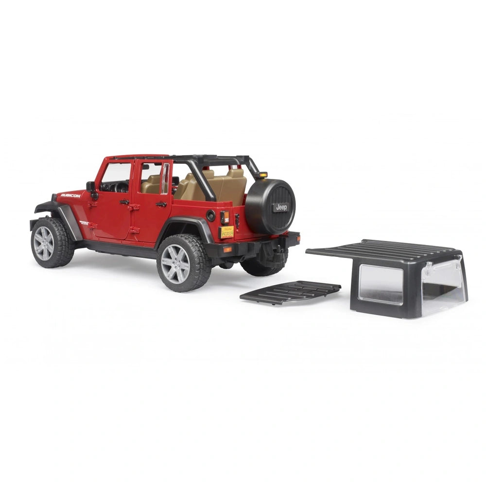 Red Bruder Jeep Wrangler toy with removable top, displayed with doors open, rugged tires, and a detachable spare tire.