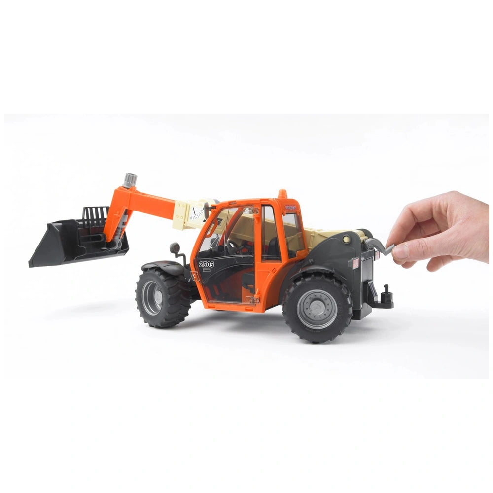 Orange and black Bruder JLG 2505 Telehandler toy with adjustable arm being operated by a hand.