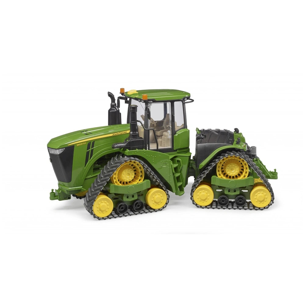 Bruder John Deere 9620RX toy tractor with green body and yellow track belts, side view.