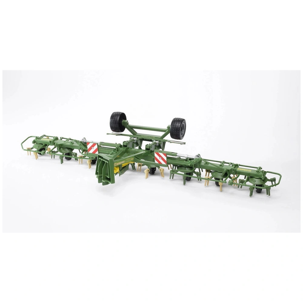 Green Bruder Krone Trailed Rotary Tedder model with detailed features, including wheels and red-striped panels, on white background.