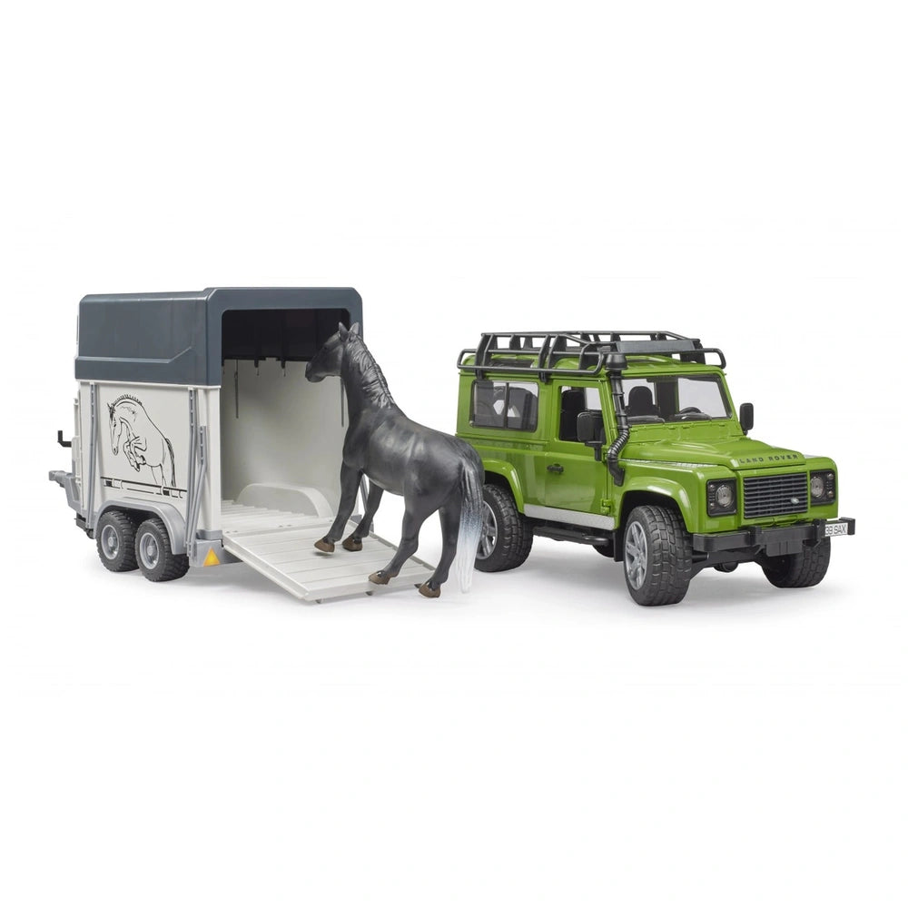 Green Land Rover Defender toy with horse trailer and gray horse entering.