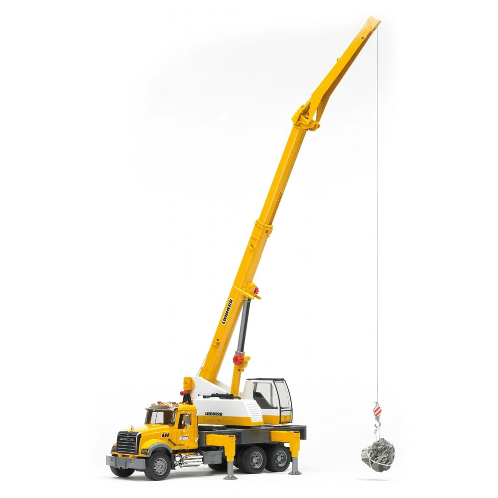 Yellow Bruder MACK Granite Liebherr Crane Truck toy with extended boom lifting a rock, sturdy support legs visible.
