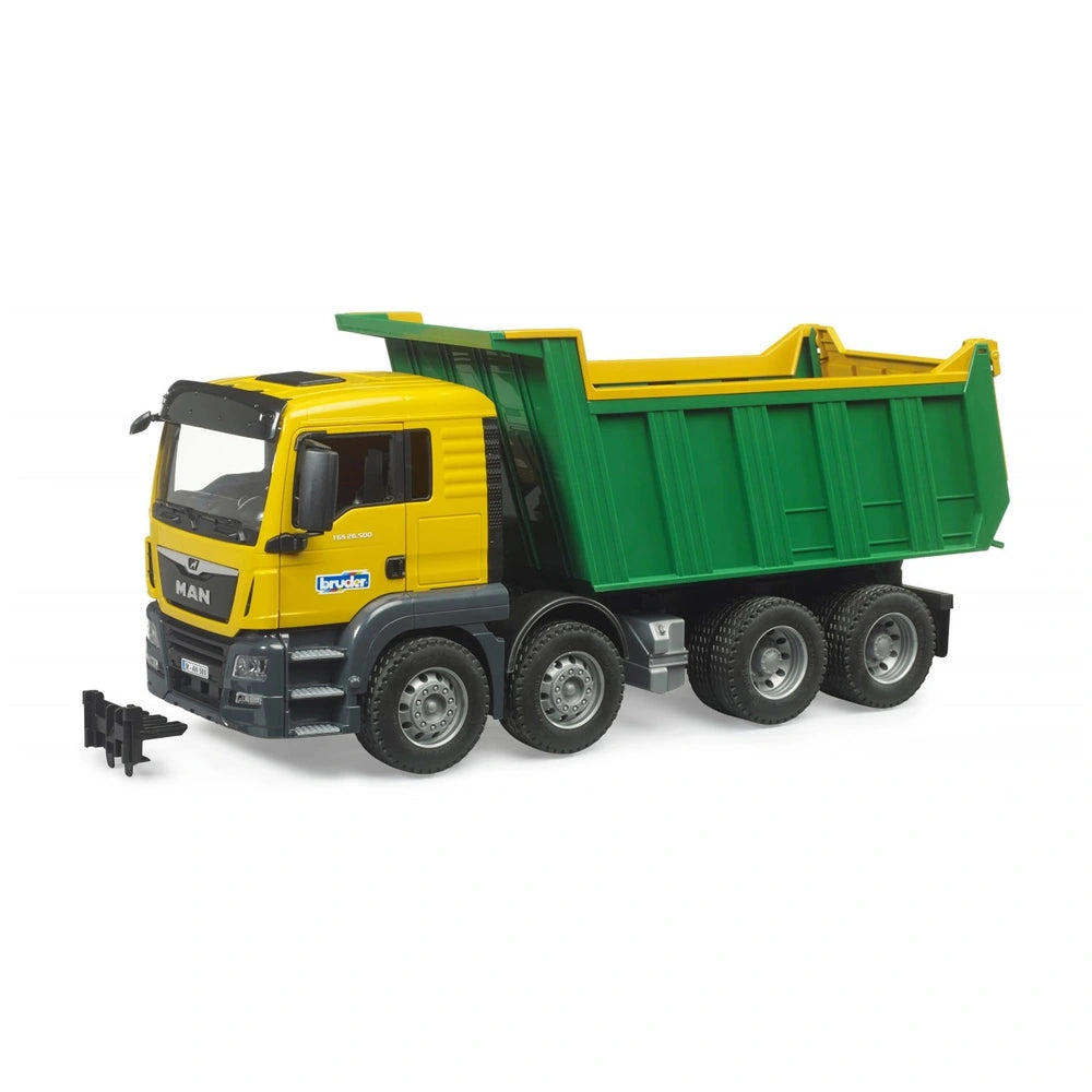 Yellow and green Bruder MAN TGS tipper truck toy with six wheels and open cab doors.