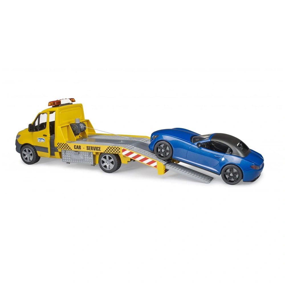 Yellow car transporter with light and sound module carrying a blue roadster toy vehicle on a tilted ramp.