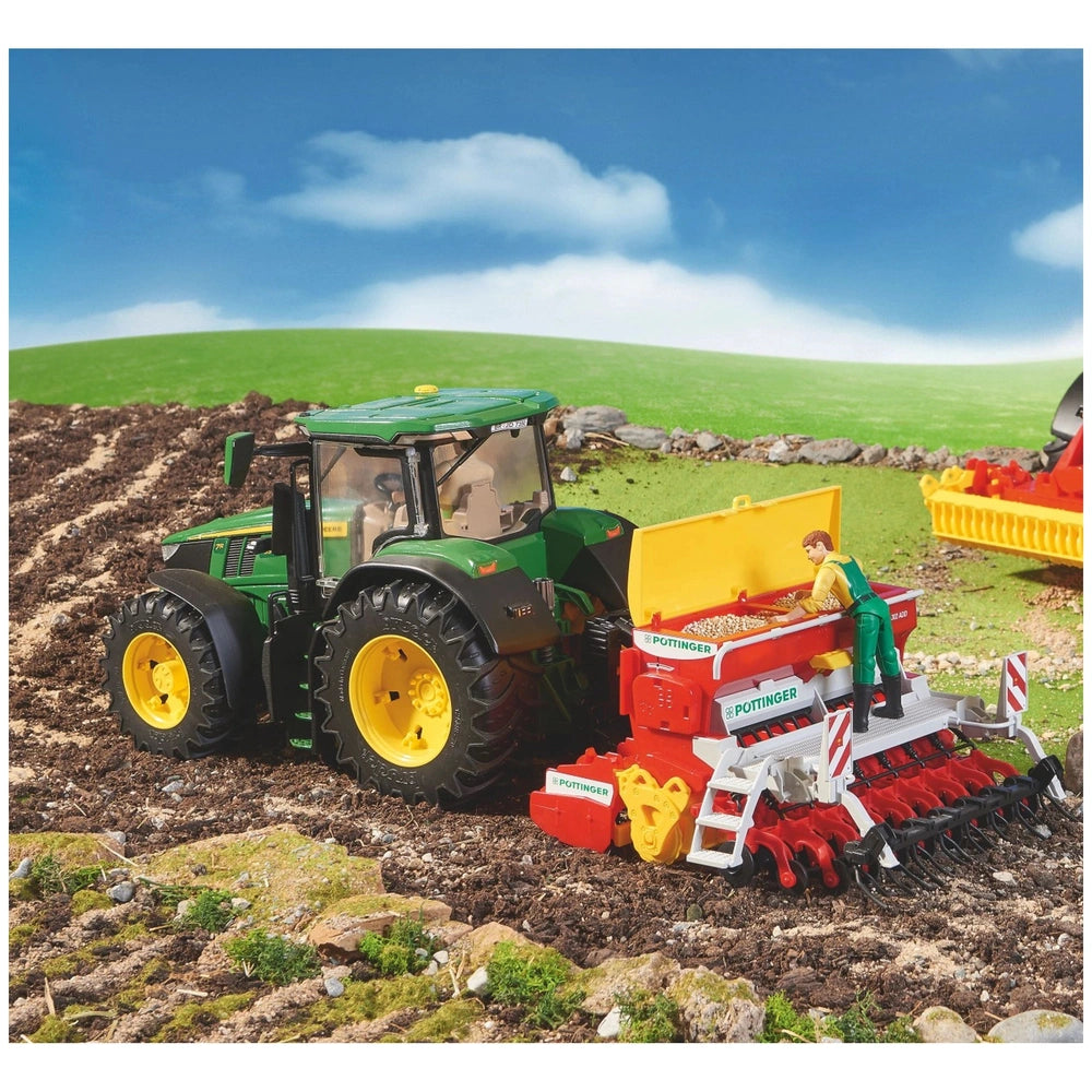 Toy tractor and harrow seeder in field, boy figurine adding seeds to Pöttinger Vitasem 302ADD under blue sky.