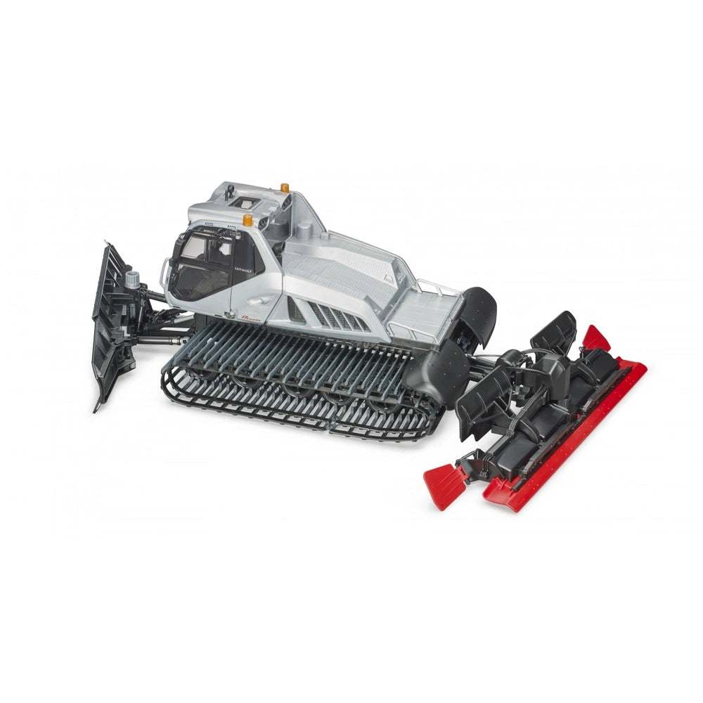 Bruder Prinoth Snow Groomer Leitwolf toy, detailed with tracks, a transparent cabin, and vibrant red snowplow attachments.