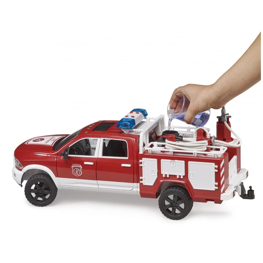 Red Bruder RAM 2500 fire engine truck toy with water being poured into its tank.
