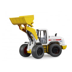Toy yellow and white wheel loader with large black tread tires, raised loading arm, Bruder branding on side.