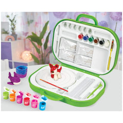 Crayola Clay Sculpting Station features a red and white toy in a green case with "100 Pieces" and arts symbols on a white sur