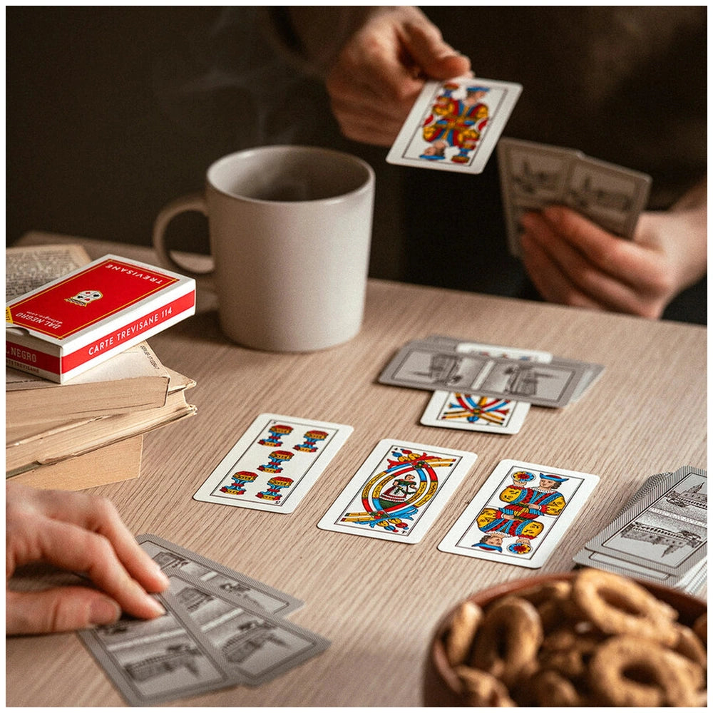 Dal Negro Trevisane Pro Cards N.114 in a red box, held by hands with a glossy cup and cookies on a brown table.