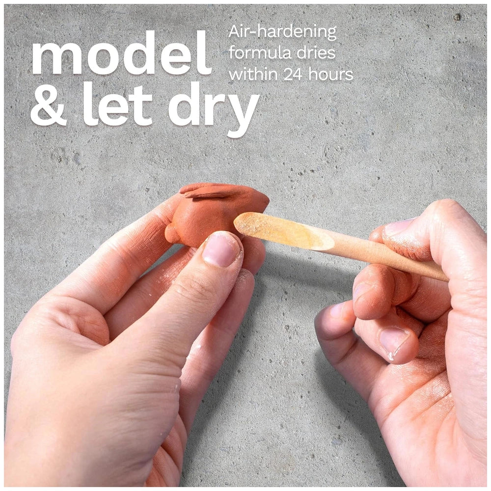 Das Modeling Clay in terra-cotta color shaped by hands, with a wooden stick on a concrete surface and "model & let dry" text.