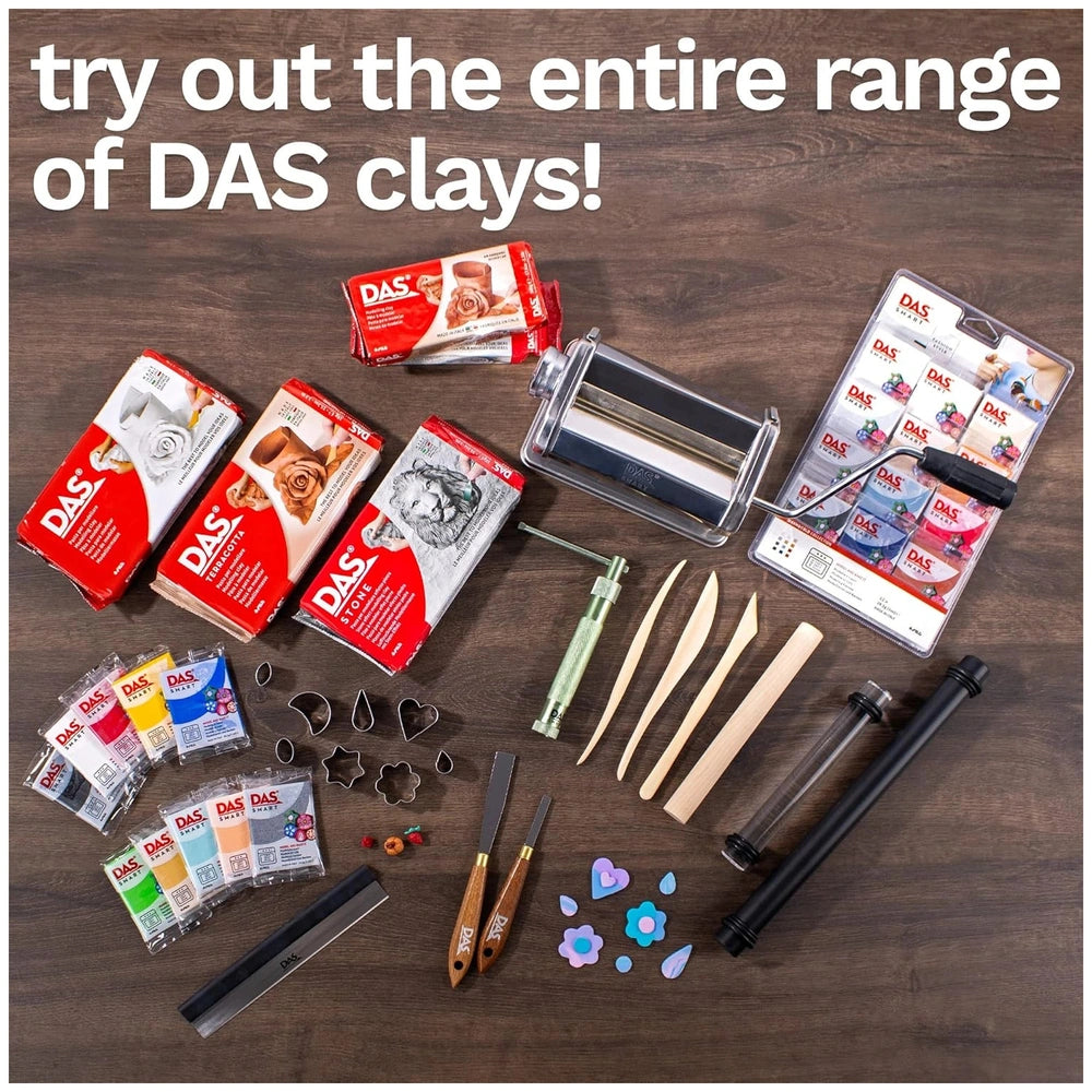 DAS Modeling Clay in red and white packaging, surrounded by crafting supplies on a wooden table.
