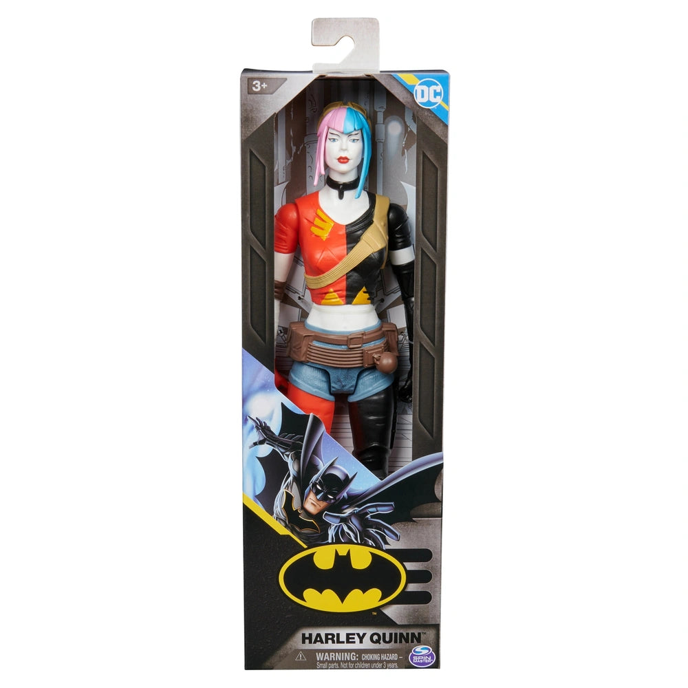 Harley Quinn action figure in colorful attire, displayed in clear packaging with a Batman logo and vibrant design elements.