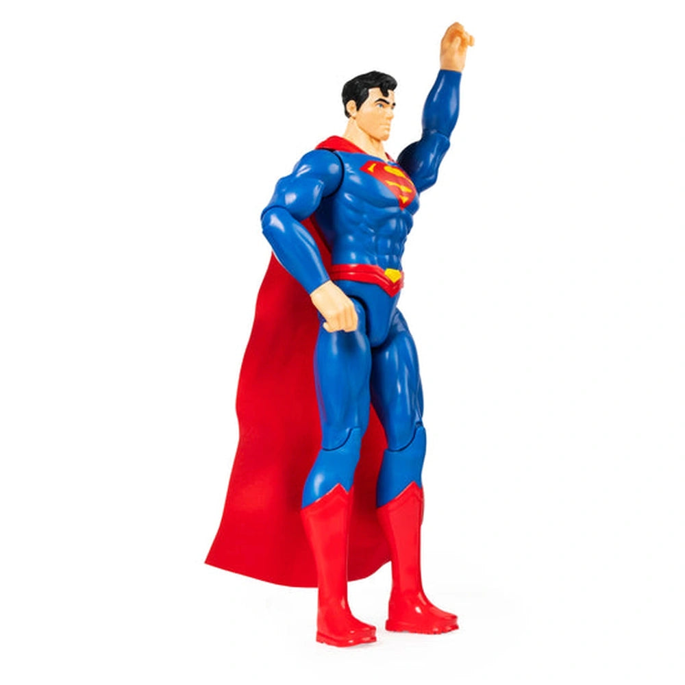 Superman action figure in blue and red, posed triumphantly with a muscular build and glossy plastic finish.