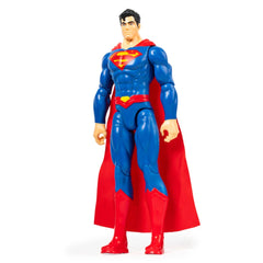 DC Comics Superman action figure stands proudly in a blue suit with a red cape, showcasing a muscular build against a white b