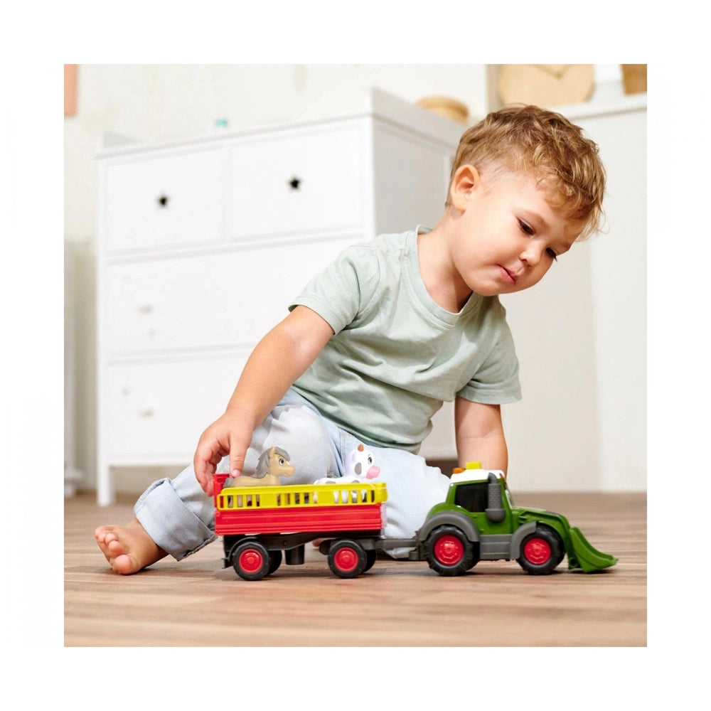 Dickie ABC Fendit Animal Trailer with lights and sounds, featuring a child in green shirt and blue pants playing on wooden fl