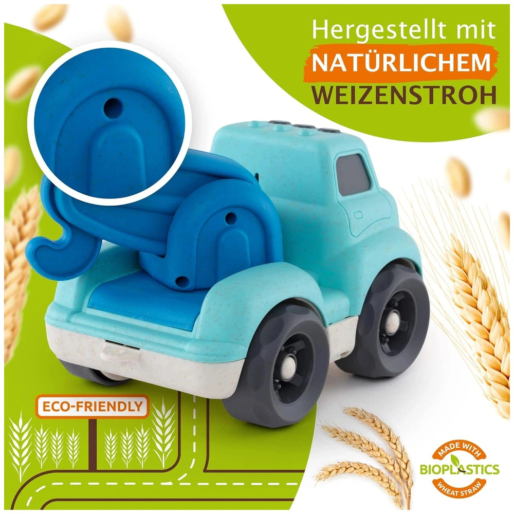 Sustainable toy truck with a blue canopy and white base on a green road, set against a wheat field backdrop.