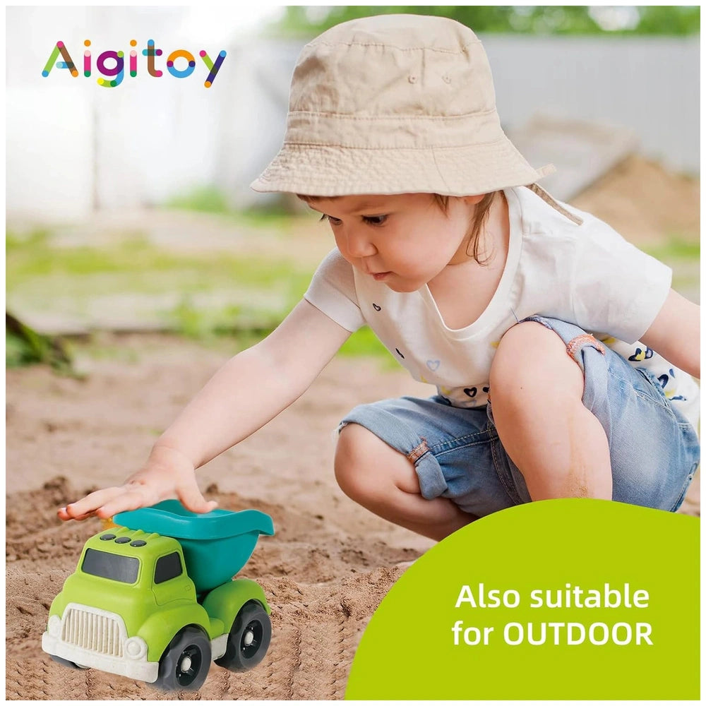 Sustainable wheat straw city vehicle in a child's hand, set against a blurred outdoor background with natural light.