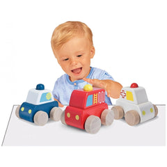 Eichhorn Baby Emergency Car with Siren is a colorful toy vehicle being played with by a smiling toddler at a light table.
