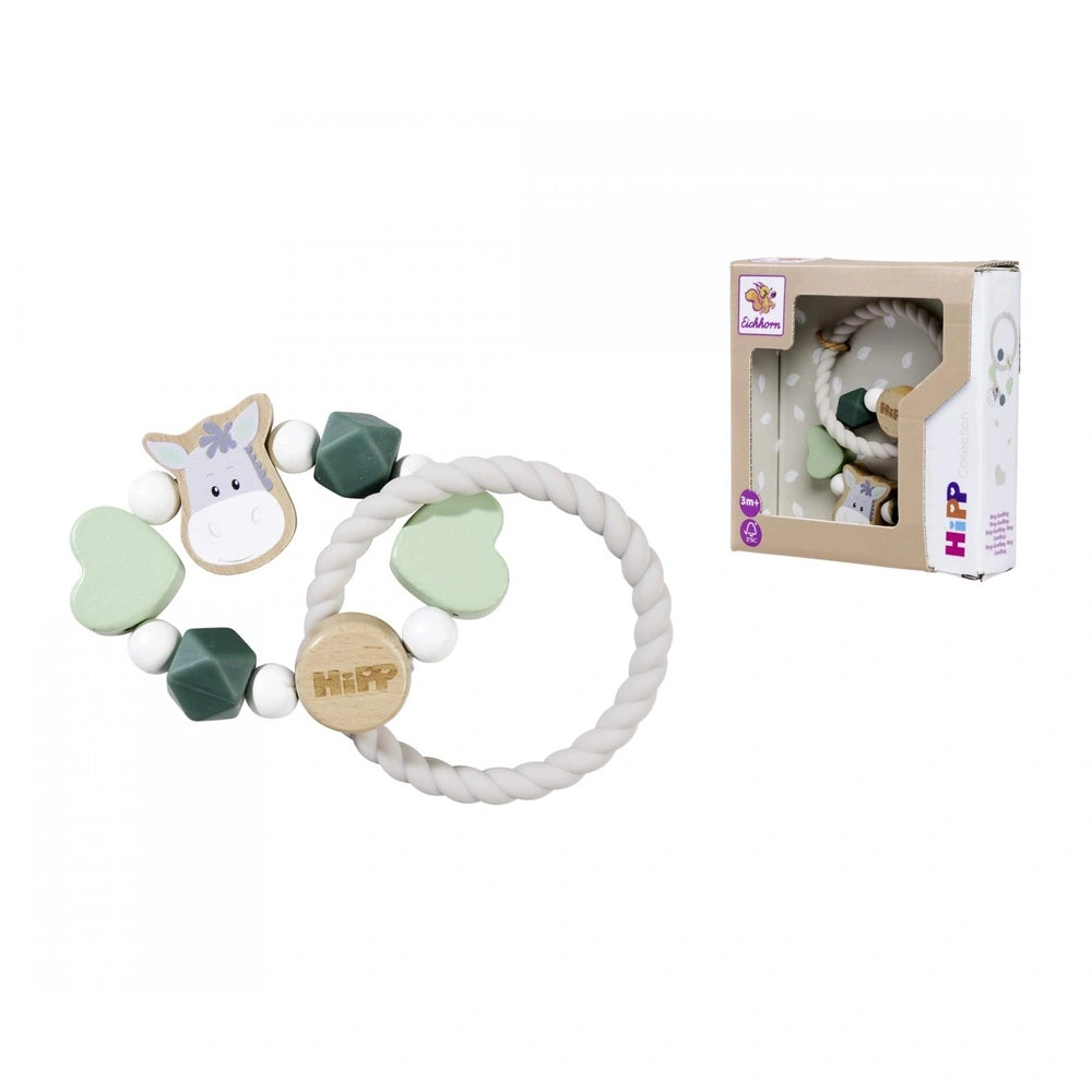 Eichhorn Baby HiPP Grapper features a light plastic toy with a face and tail, alongside a fabric bracelet with a heart design