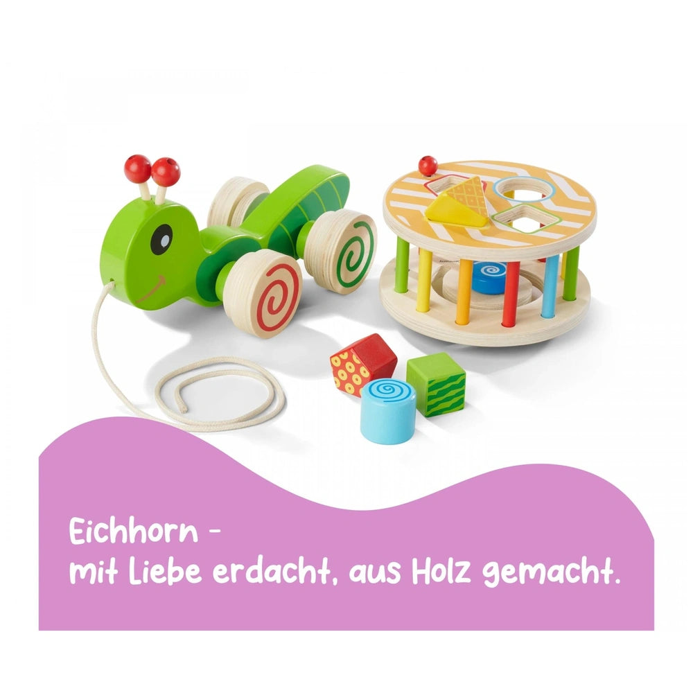 Colorful Eichhorn pull-along stacking animal toy set with a green convertible car on a striped wooden track and scattered blo