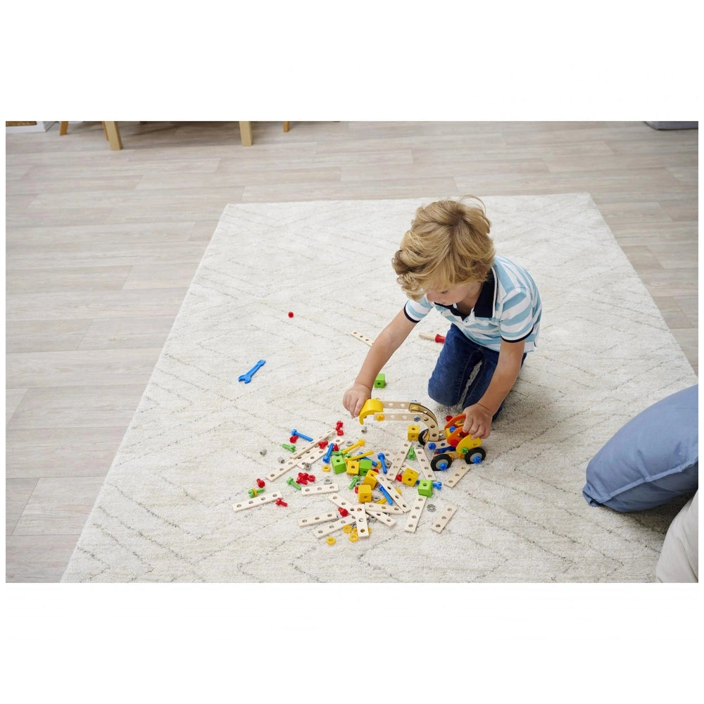 Eichhorn Constructor 3in1 construction set with wooden pegs and plastic connectors, as a child plays on a carpeted floor.