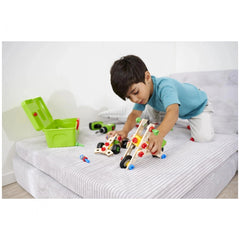 Eichhorn Constructor 3in1 Race Car construction set is being actively played with by a focused child on a bed.