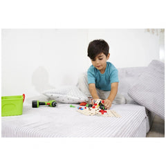 Eichhorn Constructor 3in1 Race Car set is being explored by a child on a bed, surrounded by colorful toys and building blocks