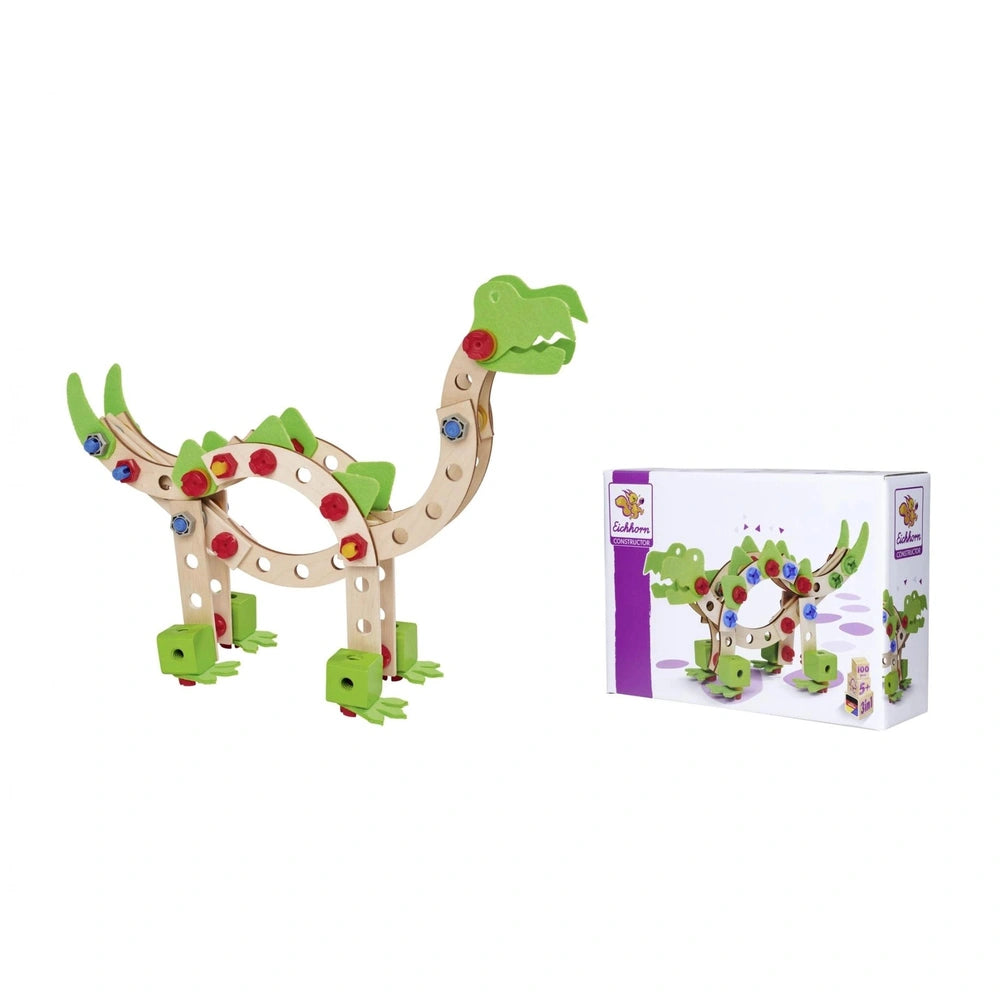 Eichhorn Constructor Dinosaur toy in green with red, yellow, and purple accents, next to its colorful box on a white backgrou
