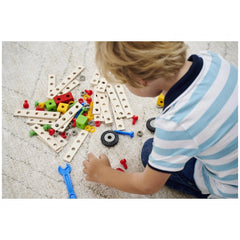 Eichhorn Constructor Expansion Set with wooden blocks and colorful connectors, featuring a child holding a blue tool on carpe