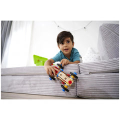 Eichhorn Constructor Racer Car set features a young boy playing with a red and yellow toy car on a gray couch.