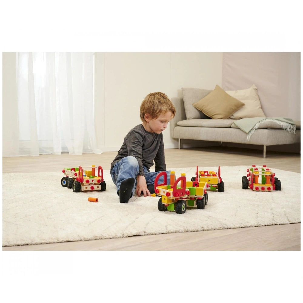 Eichhorn Constructor Truck construction set, featuring a young boy playing on a shaggy carpet with a colorful red and yellow