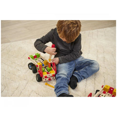 Eichhorn Constructor Truck construction set with colorful blocks held by a child on a patterned white rug.