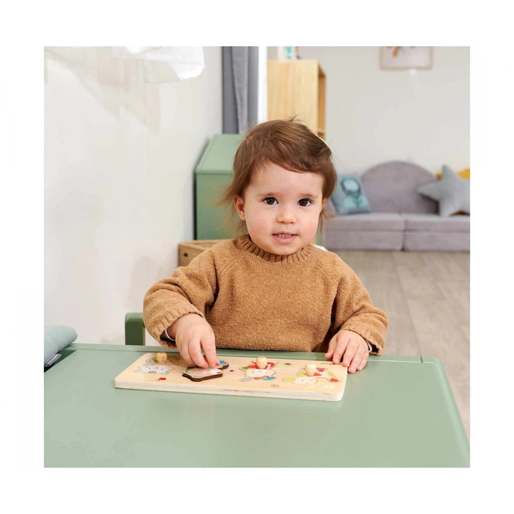 Eichhorn Puzzle Friends featuring a young child playing at a light green table in a cozy indoor environment.