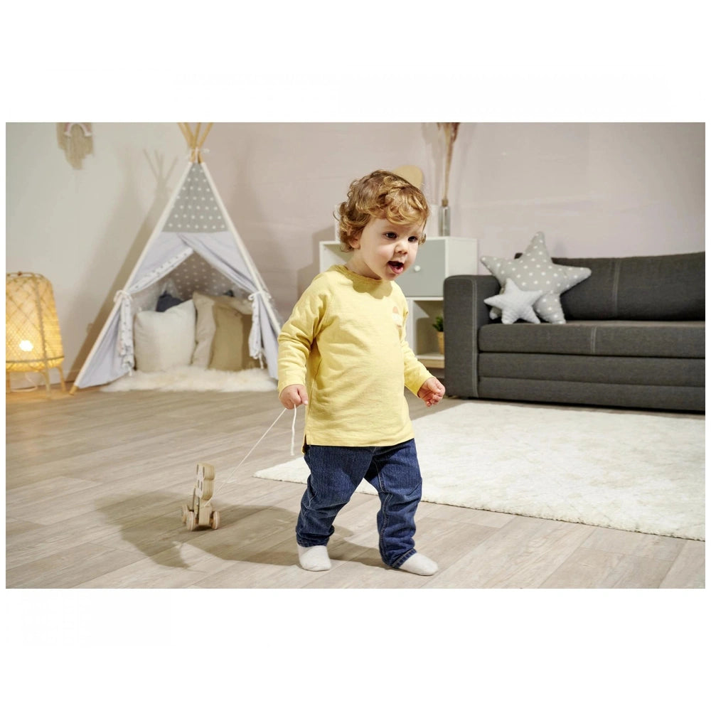 Eichhorn Wooden Pull Animal Panda toy being used by a child in a warm, playful room with a teepee and wooden train.