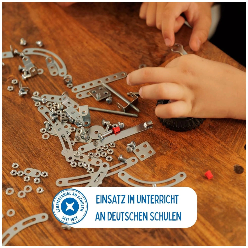 Eitech Rubin Rocket Racer red construction set toy with metal brackets, screws, and black plastic parts on a wooden tabletop.