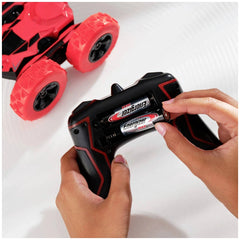 Energizer Max AA battery pack with red and white logo, placed on a smooth surface beside a red toy car with glossy wheels.
