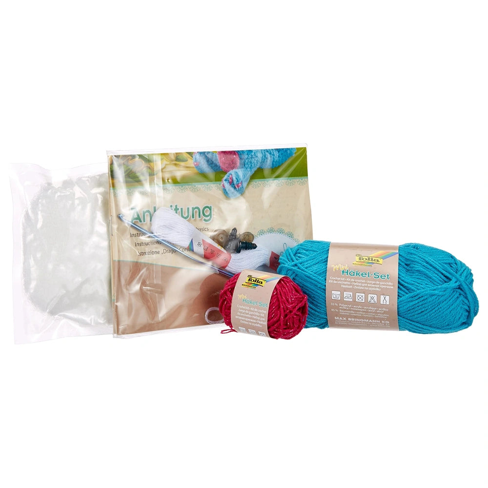 Mini Crochet Kit featuring a blue dragon with scissors and blue yarn with red thread in a matte and glossy beige packaging.