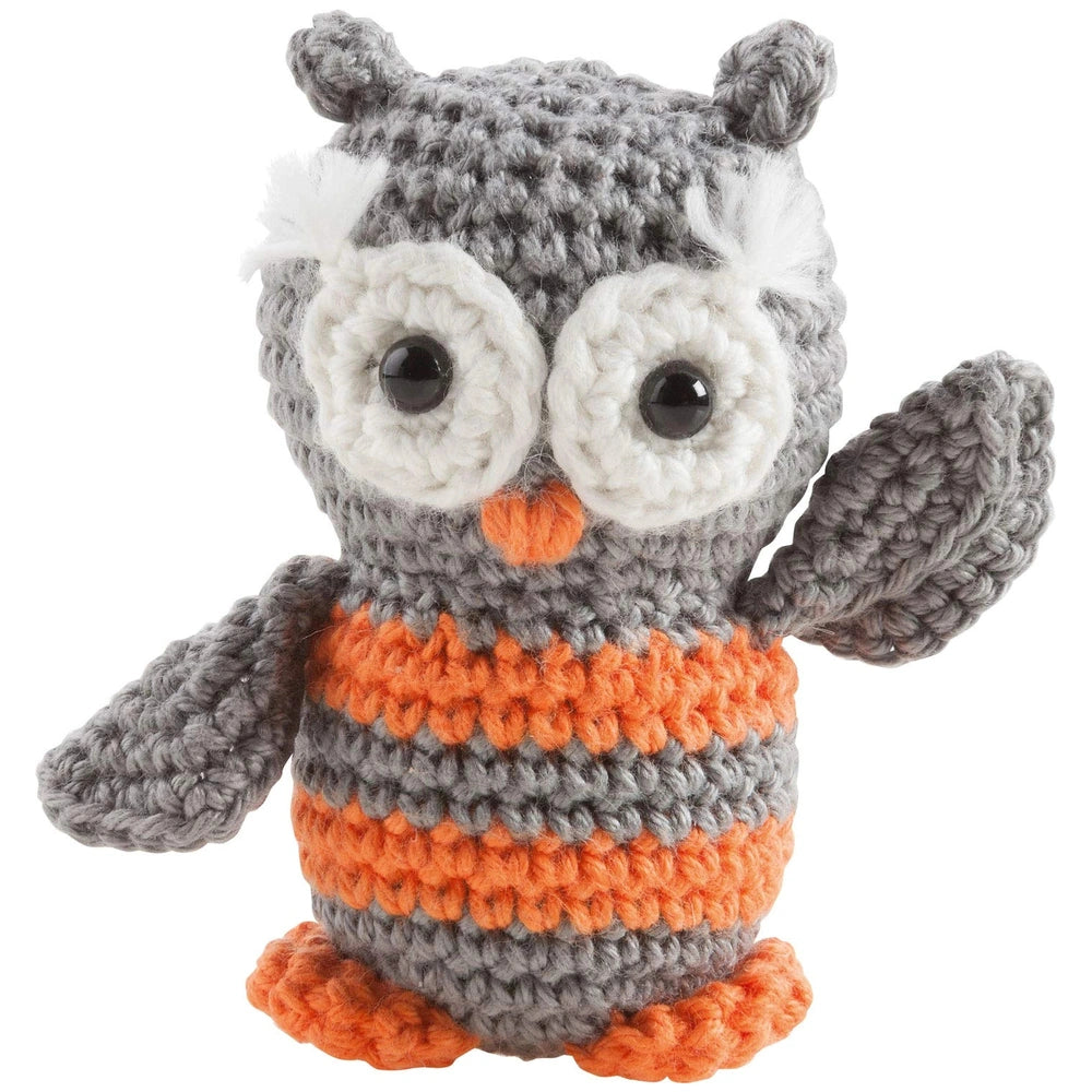 Mini crochet kit featuring a gray and orange striped knitted owl with black plastic eyes and an orange beak.