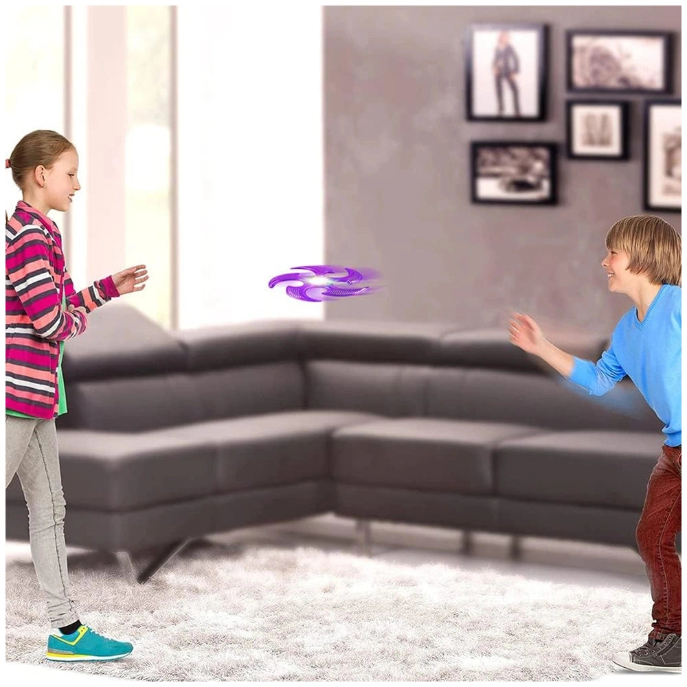 Globo Frisby Ninja with lights being played with by two children on a white shag rug in a light gray living room.