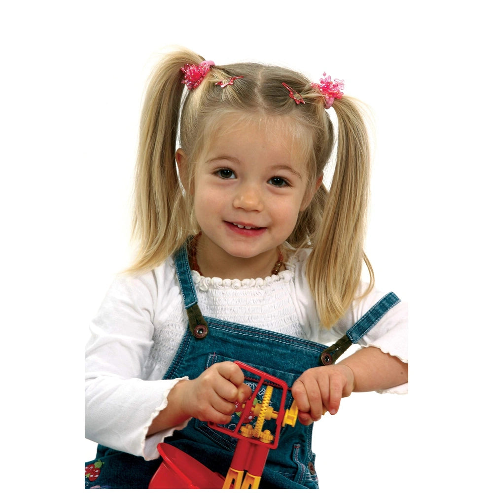 Gowi Baking Set Salzburg features a young girl in a blue jumpsuit holding a red and yellow toy, styled with blonde pigtails.