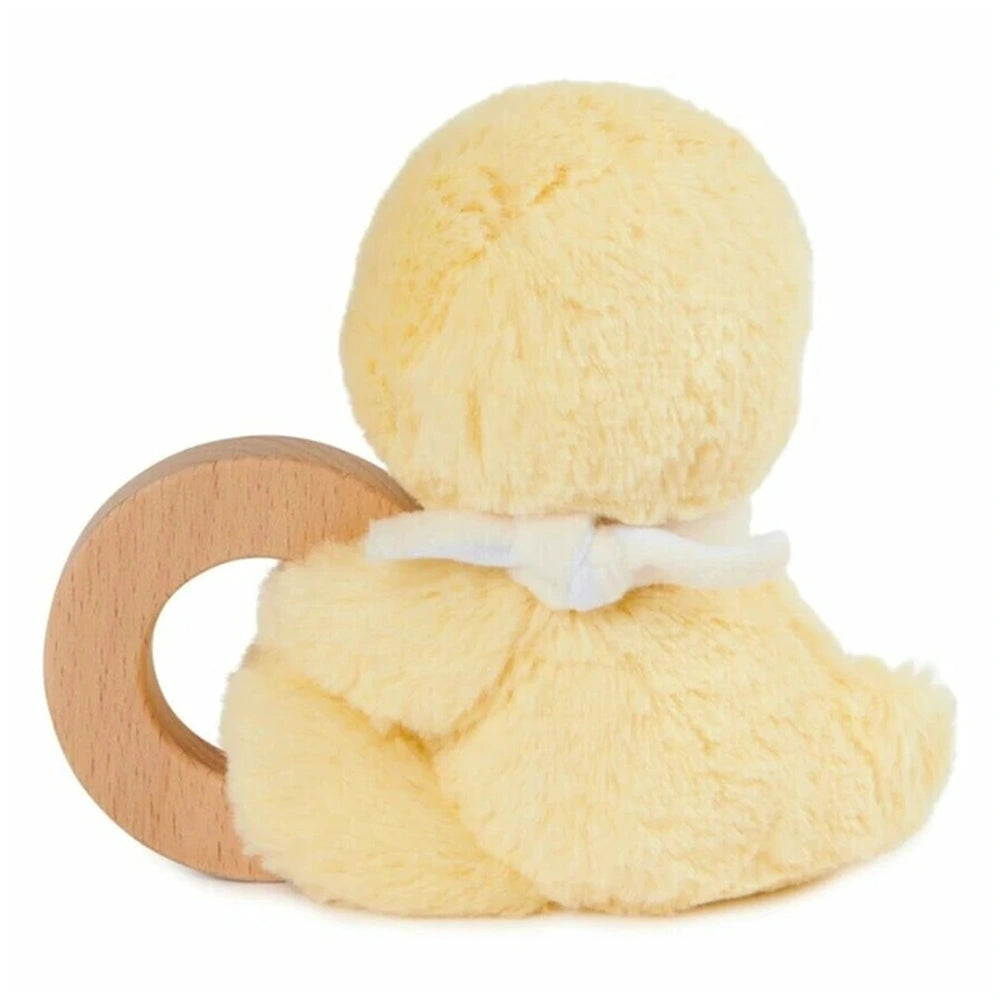 Gund Soft Animal Ring Rattle is a light-colored plush toy with a fluffy texture, sitting upright on a wooden base.